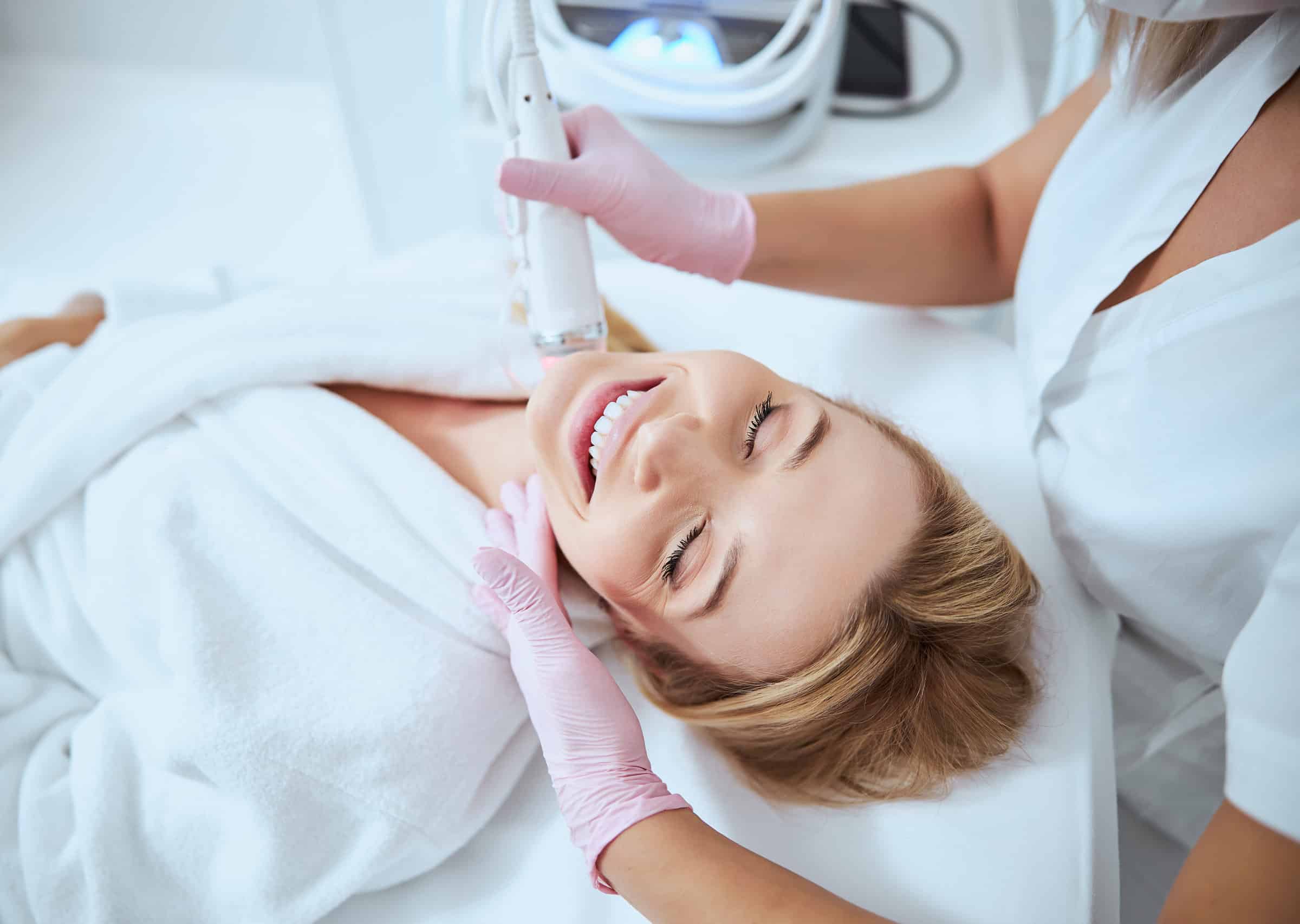 young female client enjoying the microneedling procedure