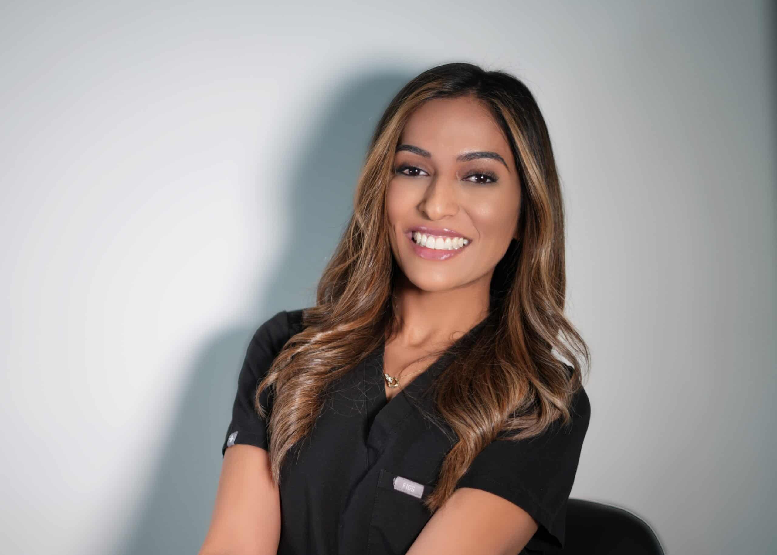 Person smiling, wearing a black shirt