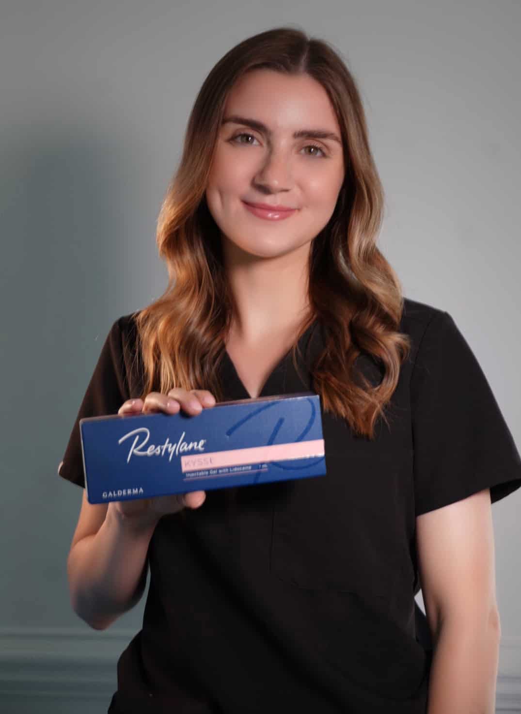 Person holding Restylane Kysse beauty product box.