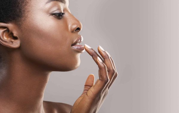 profile portrait of beautiful african american girl touching her lips]