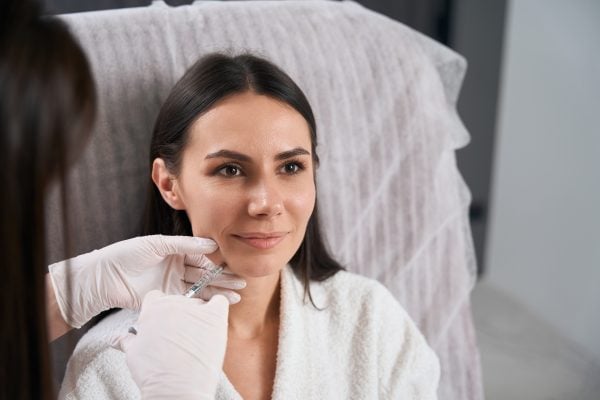 Woman receiving cosmetic injection at clinic