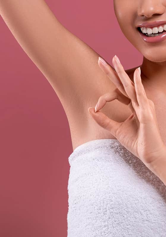 asian woman lifting hand up, showing clean and hygienic armpits