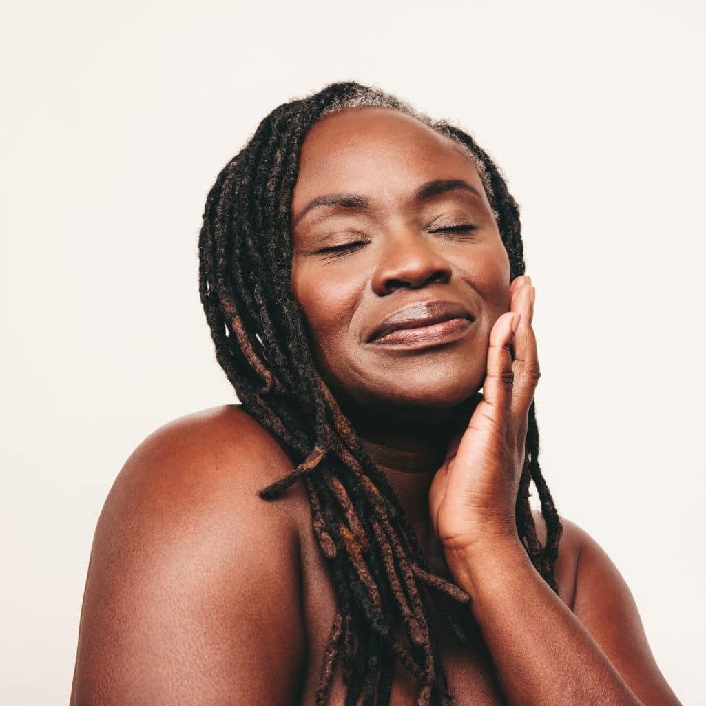 Woman enjoying peaceful moment, eyes closed.