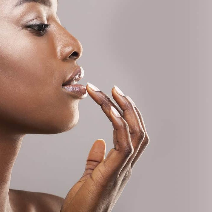 profile portrait of beautiful african american girl touching her lips profile portrait of beautiful african american girl touching her lips