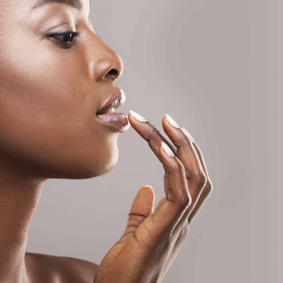 profile portrait of beautiful african american girl touching her lips]